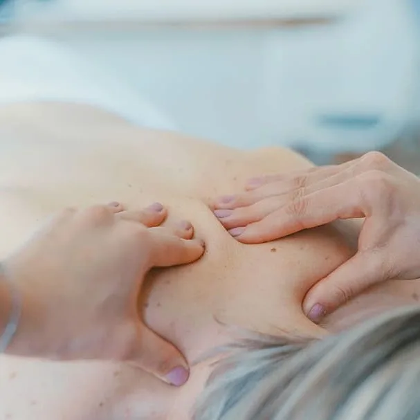 Gentle hands-on acupressure treatment on a patient's back — the kind of care Ken brings directly to your home